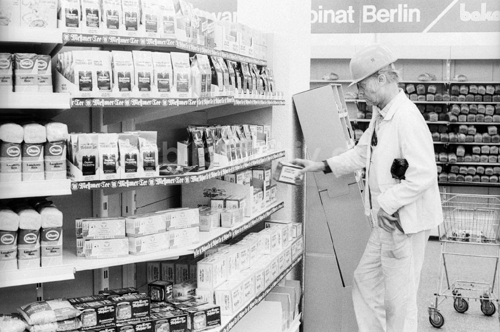 DDR-Bildarchiv: Berlin - Bauarbeiter mit Helm steht vor einem Regal in einer Kaufhalle in Berlin, der ehemaligen Hauptstadt der DDR, Deutsche Demokratische Republik