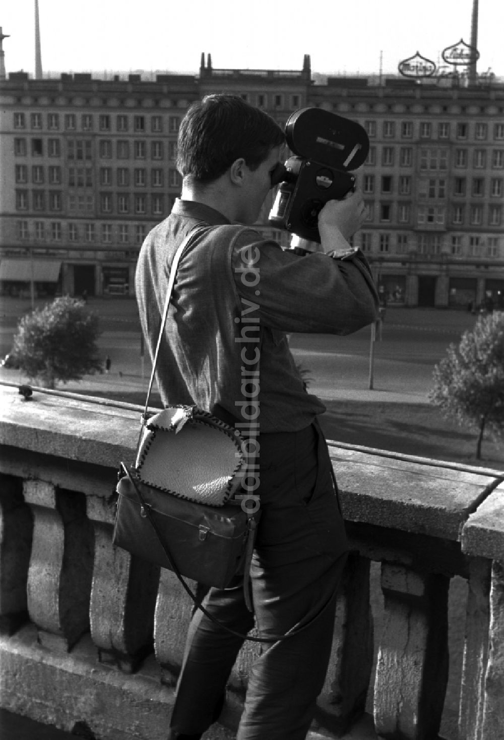 DDR-Fotoarchiv: Berlin - Mitte - Ein junger Mann steht auf einem Balkon und filmt mit einer 16 mm Filmkamera in Berlin - Mitte 