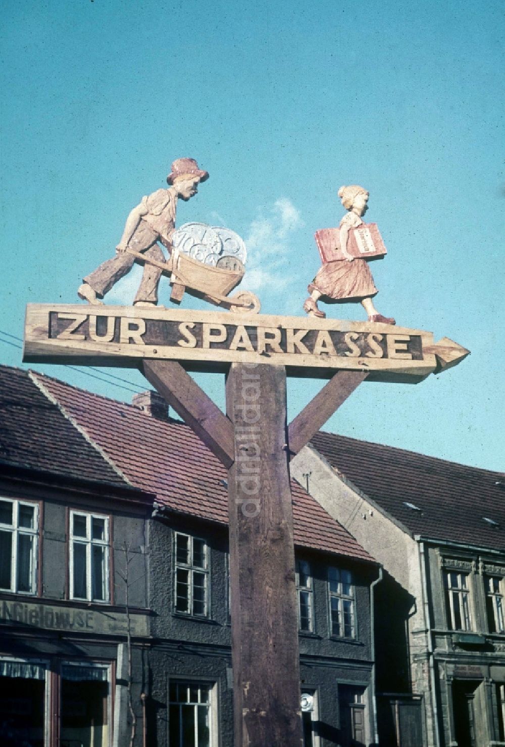 Neustrelitz: Geschnitzter Wegweiser aus Holz in Neustrelitz in Mecklenburg-Vorpommern in der DDR