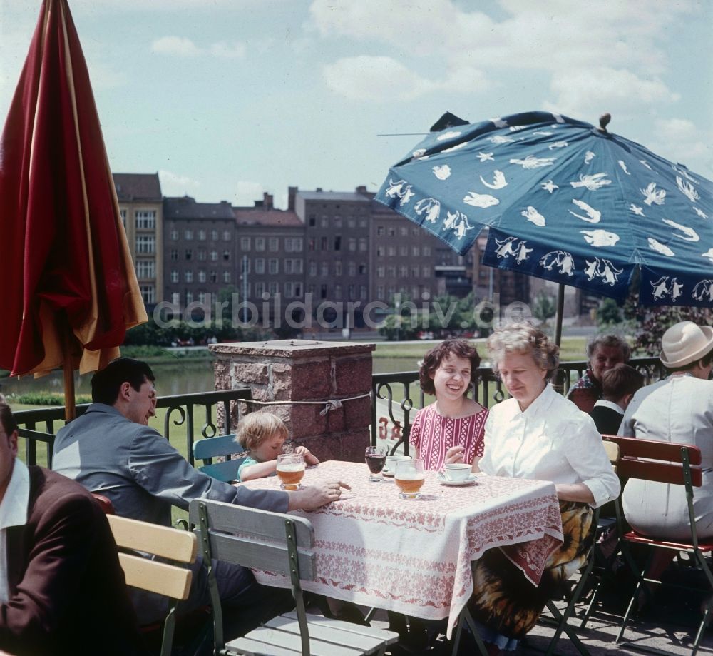 Berlin: Junge Familie in der Freiluftgaststätte am Ermelerhaus in Berlin, der ehemaligen Hauptstadt der DDR, Deutsche Demokratische Republik