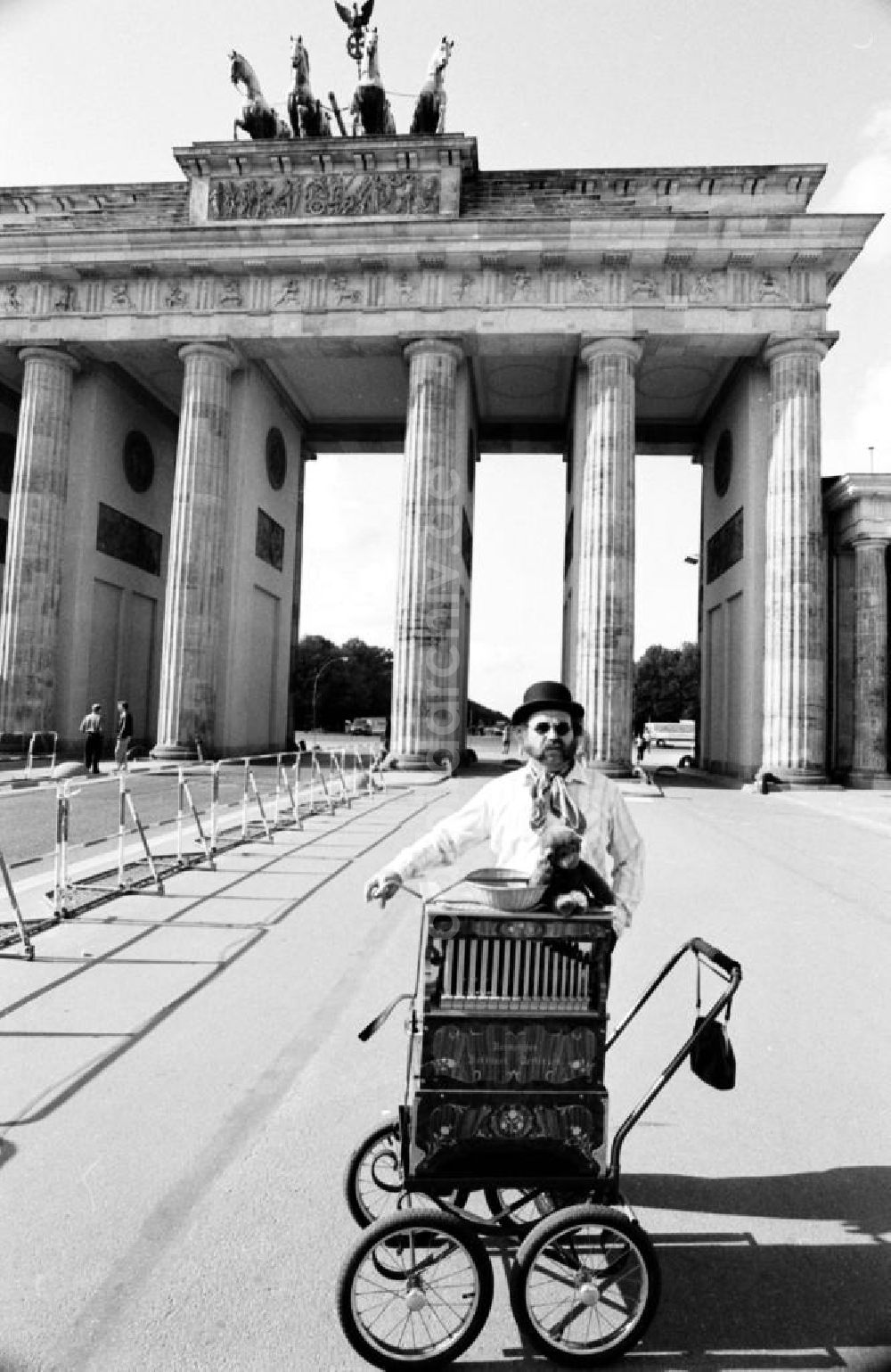 DDR-Fotoarchiv: Berlin-Mitte Berlin-Tiergarten - Leierkastenmann steht am Leierkasten vor Brandenburger Tor in Berlin