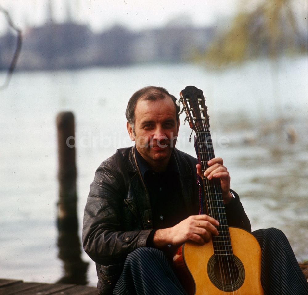 DDR-Fotoarchiv: Berlin - Schauspieler Armin Mueller-Stahl beim Gitarrenspiel am Ufer der Dahme in Berlin - Köpenick