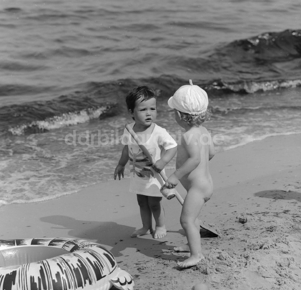 Ückeritz: Zwei kleine Kinder am Strand in Ückeritz im Bundesland Mecklenburg-Vorpommern auf dem Gebiet der ehemaligen DDR, Deutsche Demokratische Republik